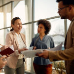 Three people talking at work.