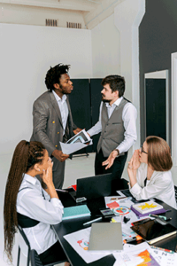 two men arguing in office while two women watch